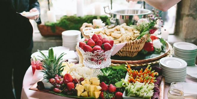 A table filled with displays of fresh fruits.