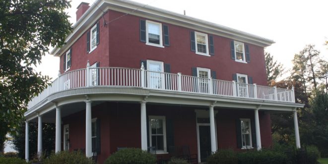 Oscar Hammerstein's home, made with red brick and a white wrap-around balcony.