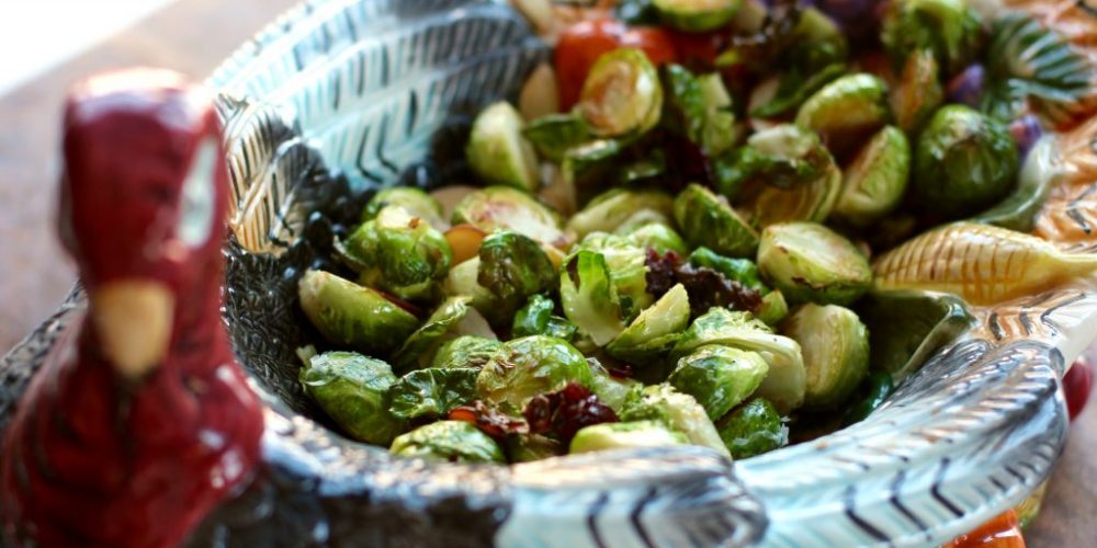 Cooked brussel sprouts are inside of a dish shaped like a turkey