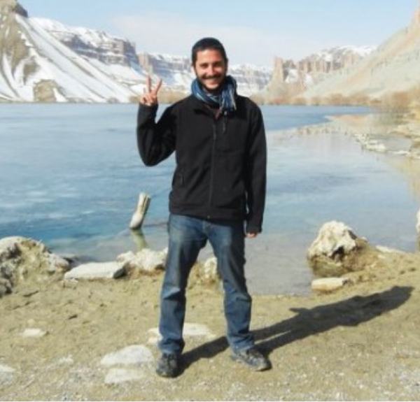 Headshot of Tim Luccaro standing in front of a mountain lake.